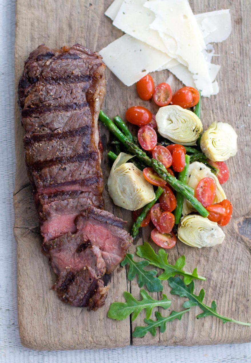 A spring vegetable salad and a grilled steak are ready for eating. Portions of the salad can be placed on the grill. (Associated Press)