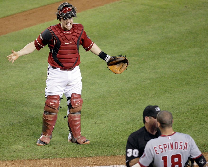 ASSOCIATED PRESS
Arizona catcher Miguel Montero (top) exchanges words with Washington second baseman Danny Espinosa, who is restrained by umpire Rob Drake on Sunday after Espinosa was hit by a pitch.