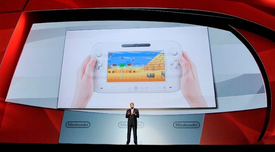 ASSOCIATED PRESS
Reggie Fils-Aime, president of Nintendo of America, introduces the Wii U gaming console at the E3 Gaming Convention in Los Angeles on Tuesday. Its controller contains a 6.2-inch touch screen so gamers can play while others watch TV.