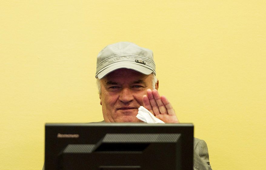 Former Bosnian Serb military chief Ratko Mladic waves in the courtroom during a hearing at the U.N.'s International Criminal Tribunal for the Former Yugoslavia in The Hague on Monday, July 4, 2011. (AP Photo/ Valerie Kuypers, Pool)