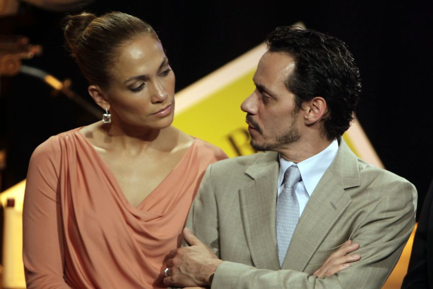 In this Friday, March 4, 2011, picture, Jennifer Lopez, left, and husband Marc Anthony attend a signing ceremony for filmmaking incentive legislation for the U.S. island territory in Bayamon, Puerto Rico. The superstar couple announced Friday, July 15, 2011, they are breaking up. The two married in 2004 and have 3-year-old twins, Max and Emme. (AP Photo/Ricardo Arduengo)