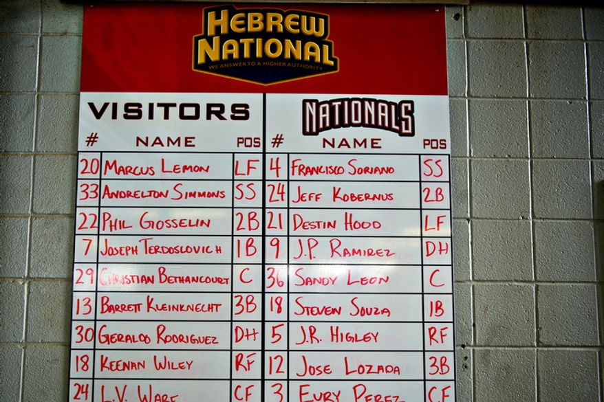 Fans are greeted by a handwritten lineup sheet on the wall of the main concourse at Pfitzner Stadium, during a game between the Potomac Nationals and Lynchburg Hillcats, in Woodbridge, Va., Tuesday, July 19, 2011. (Drew Angerer/The Washington Times)