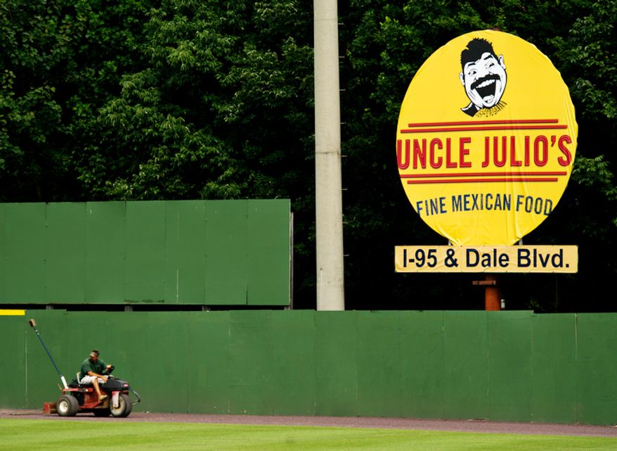 A member of the grounds crew readies the field for play, at Pfitzner Stadium, prior to a game between the Potomac Nationals and the Lynchburg Hillcats, in Woodbridge, Va. (Drew Angerer/The Washington Times)