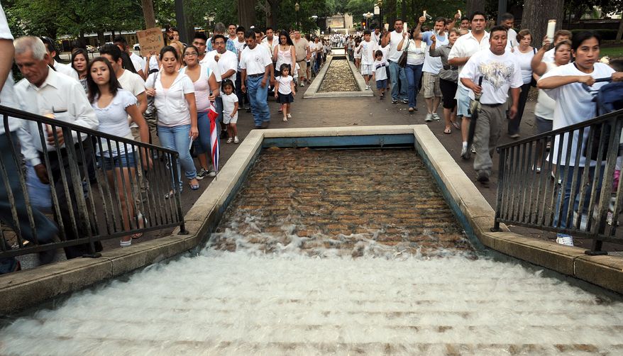 **FILE** Demonstrators protesting Alabama's new law against illegal immigration march through Linn Park in Birmingham, Ala., on June 25, 2011. (Associated Press/The Birmingham News)