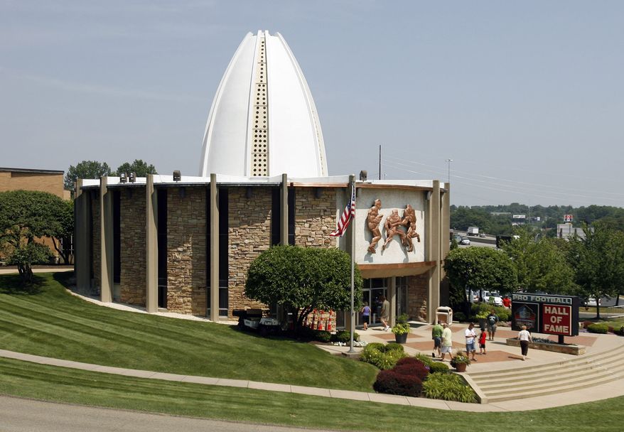 Pedestrians walk around the entrance of the Pro Football Hall of Fame, Friday, July 22, 2011 in Canton, Ohio. Although the NFL announced Thursday, July 21, the cancellation of the annual Hall of Fame Game between the Chicago Bears and the St. Louis Rams, the enshrinement will go ahead as plannned. Deion Sanders, Chris Hanburger, Les Richter, Ed Sabol, Shannon Sharpe, Richard Dent, and Marshall Faulk represent the Class of 2011 who will be enshrined on Aug. 6, 2011. (AP Photo/The Repository, Scott Heckel)