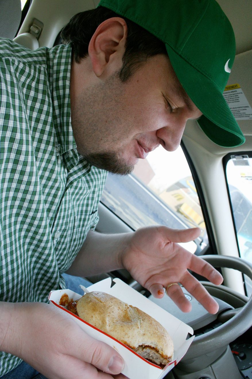 Alan Klein enjoys a McRib. He created the McRib Locator website to help enthusiasts track where McDonald's is offering the elusive sandwich. (Associated Press)