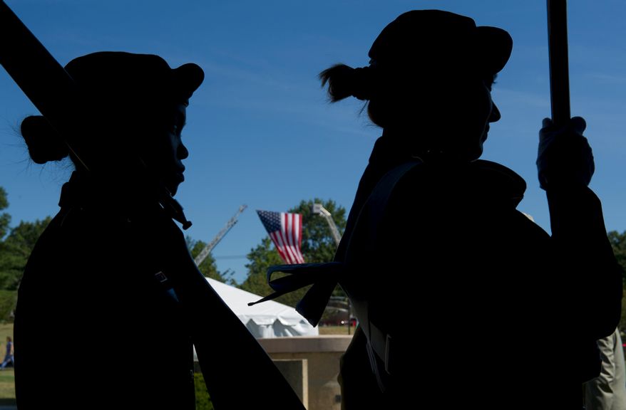 Members of the Army Color Guard wait to bring in the flag while a large U.S. flag hangs from firetrucks behind them at Walter Reed Army Medical Center in Washington, D.C., on Wednesday, July 27, 2011. The medical center held a ceremony Wednesday to officially "case the colors" as a transition to medical services at Bethesda Naval Medical Center and Ft. Belvoir. The flags of the various Walter Reed medical units were retired by rolling them up and covering them. (Barbara L. Salisbury/The Washington Times)