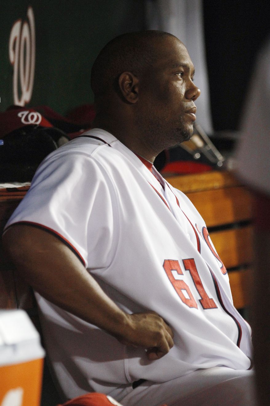 Washington Nationals starting pitcher Livan Hernandez watches the game after being pulled in the fifth inning against the Florida Marlins on Wednesday. He gave up four runs and the Marlins won 7-5. (AP Photo/Jacquelyn Martin)