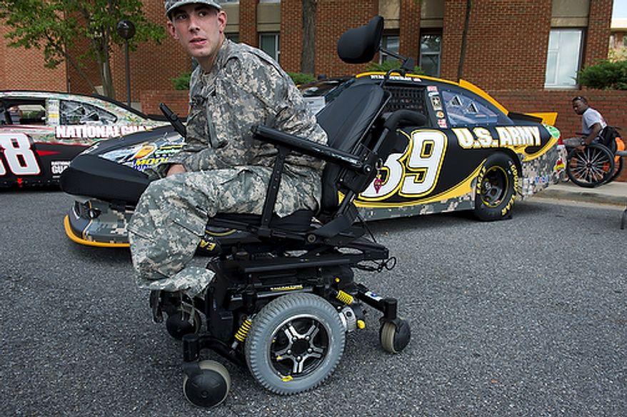 "They can take my legs, but they can't take my pride," says Brooklyn, N.Y. native and U.S. Army PFC Bryan Dilberian, who has been at Walter Reed Army Medical Center for a month and says he can't wait to redeploy to Afghanistan. PFC Dilberian was among the wounded warriors who came out to check out the NASCAR cars at Walter Reed Army Medical Center in the District on Thursday. Several NASCAR drivers visited the facility. The event ended with a dinner and a concert by singer Billy Ray Cyrus. (Barbara L. Salisbury/The Washington Times)