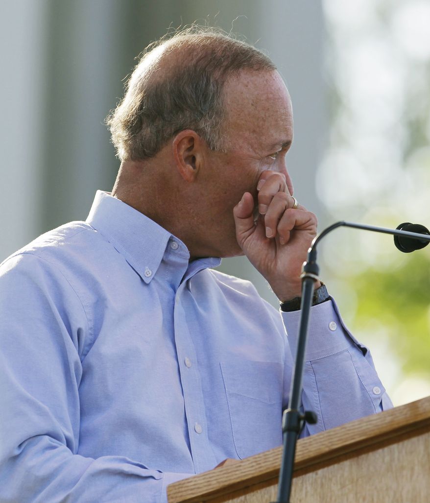 Indiana Gov. Mitch Daniels wipes a tear during a memorial service for the five people who were killed when a stage collapsed Saturday at the Indiana State Fair. (AP Photo/Darron Cummings)
