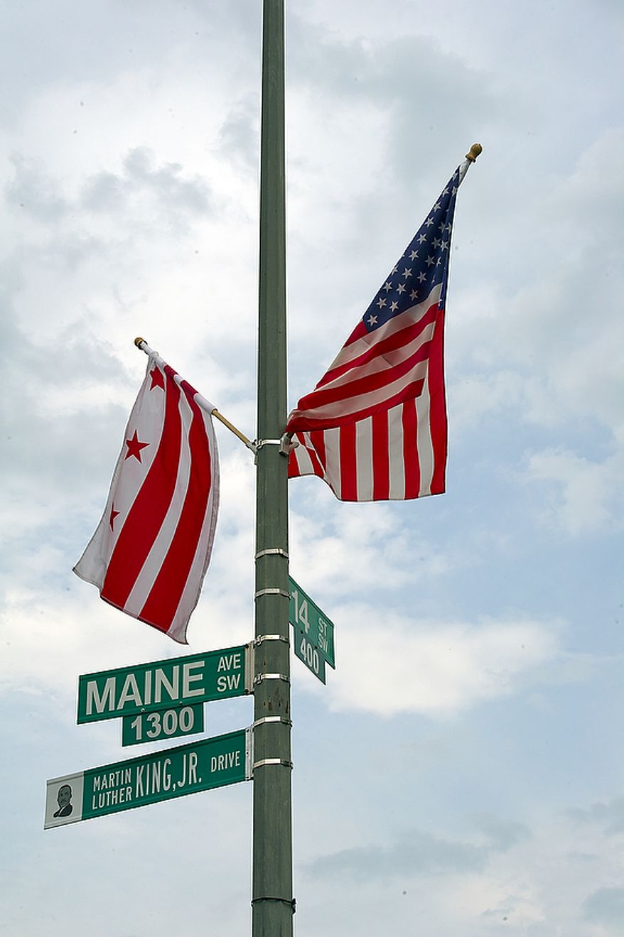 The newly unveiled Martin Luther King Jr. Drive sign sits below the Maine Avenue S.W. sign at the corner of Maine Avenue and 14th Street S.W. on Thursday, Aug. 25, 2011, the day that this part of Maine Avenue was officially renamed. The road will continue along the Southwest Freeway and join up with the other part of Martin Luther King Jr. Drive in Southeast. The sign is unusual in that it has a likeness of Dr. King on it. (Barbara L. Salisbury/The Washington Times)
