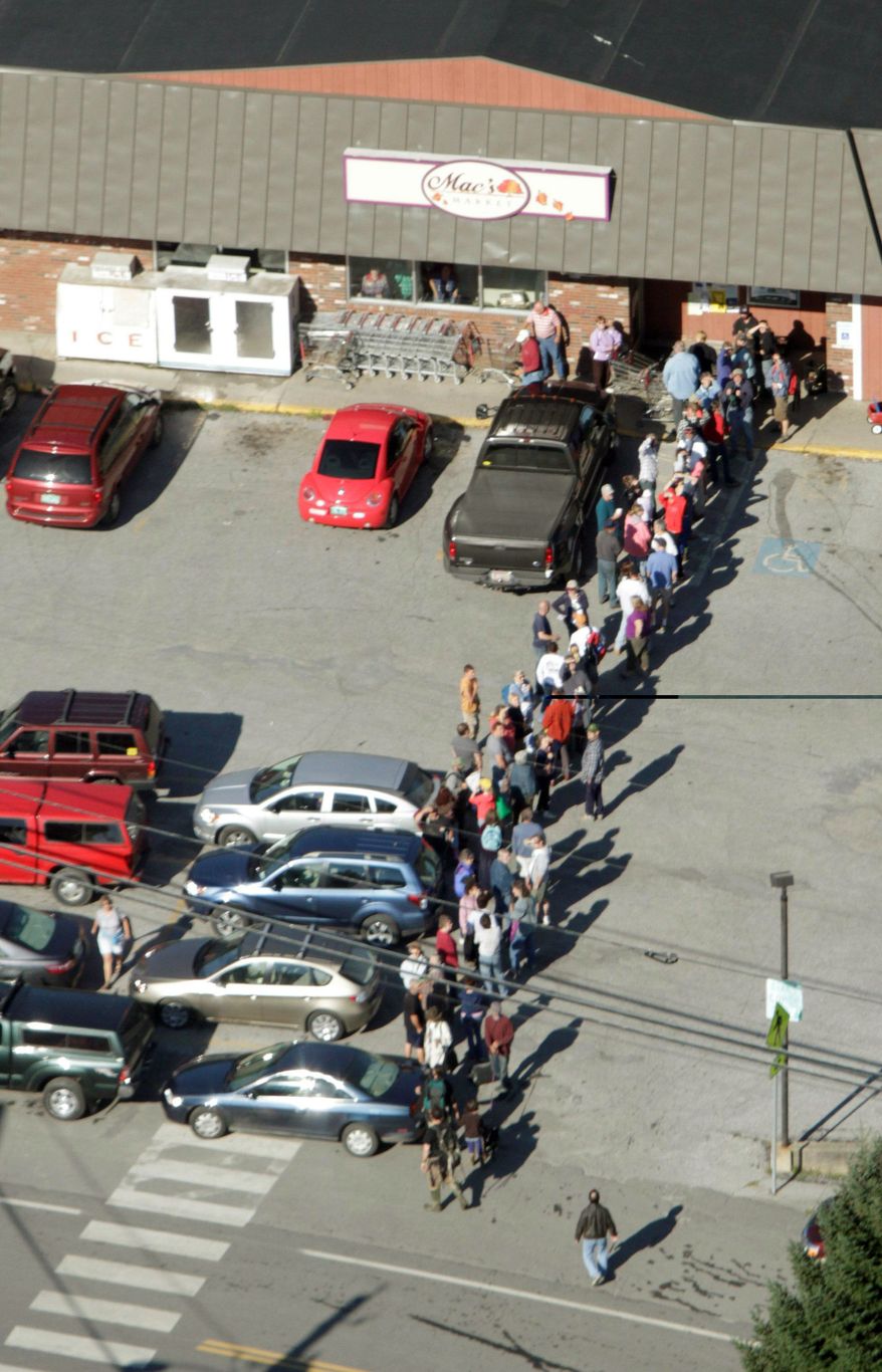 CUSTOMERS: Residents wait outside the grocery store in Rochester, Vt., inaccessible since Tropical Storm Irene hit. It is one of many small towns in the state to receive supplies Tuesday via a National Guard airlift. (Associated Press)