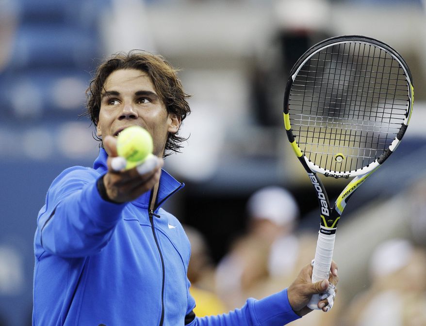 Rafael Nadal of Spain hits a ball into the stands after winning a quarterfinal match against Andy Roddick at the U.S. Open tennis tournament in New York, Friday, Sept. 9, 2011. (AP Photo/Matt Slocum)
