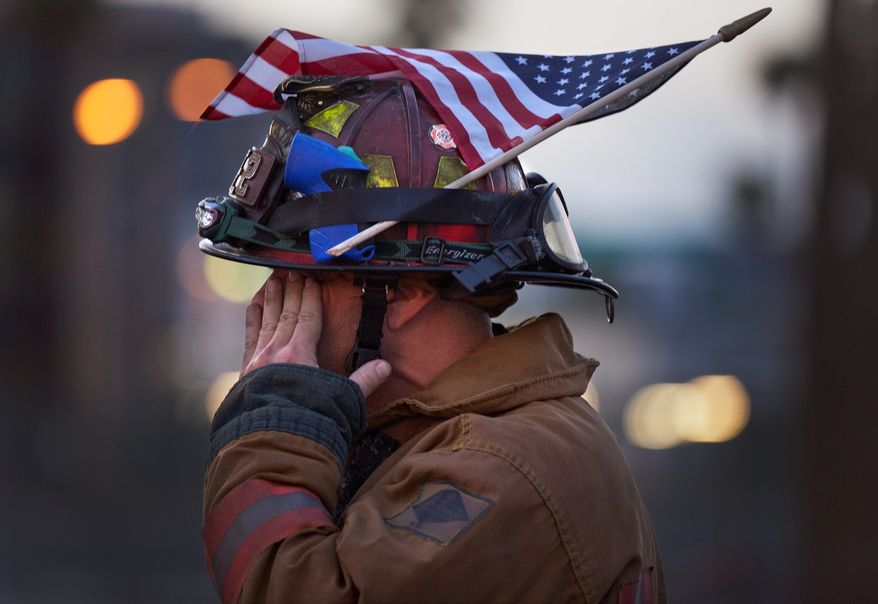 Las Vegas Fire Department Capt. Eric Littmann takes part Sunday in a parade in Las Vegas commemorating lives lost in that act of infamy. (Associated Press)