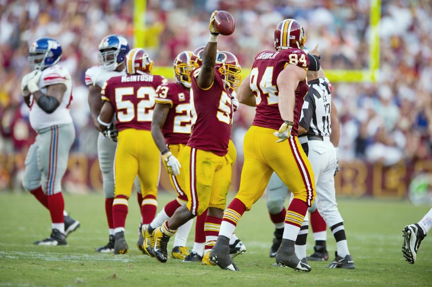 Linebacker London Fletcher (holding ball), who joined the Redskins in 2007, said, "You enjoy coming to work. That hasn't always been the case." (Andrew Harnik/The Washington Times)