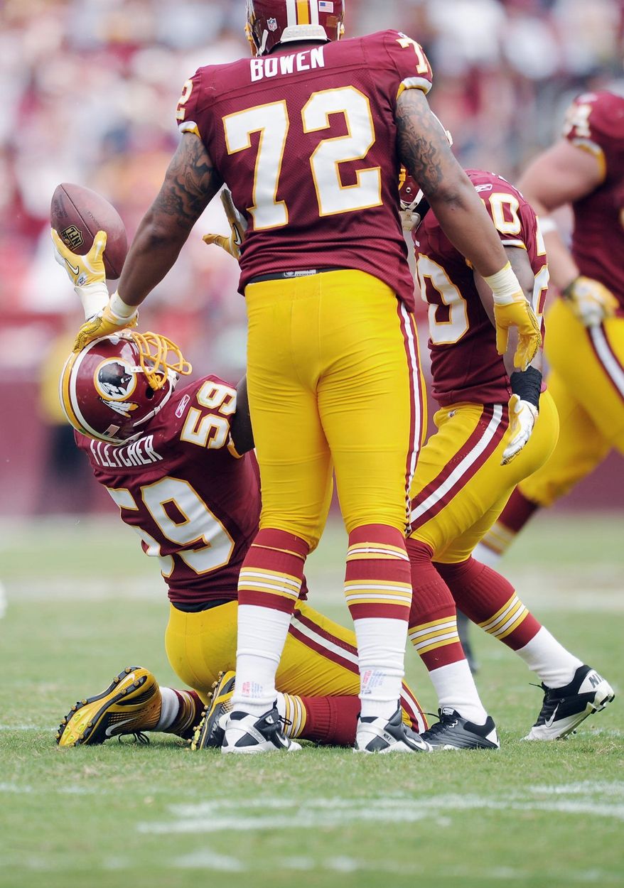 Andrew Harnik/The Washington Times
London Fletcher, here celebrating a third-quarter interception Sunday, is a 14-year veteran who has been with the Redskins since 2007.