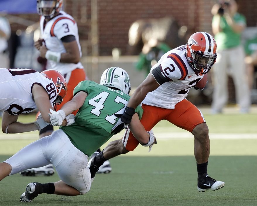 Virginia Tech's Josh Oglesby evades a tackle by Marshall's Tyson Gale on Saturday, Sept. 24, 2011, in Huntington, W.Va. Virginia Tech won 30-10 and Oglesby rushed for 75 yards and two touchdowns. (AP Photo/Randy Snyder)