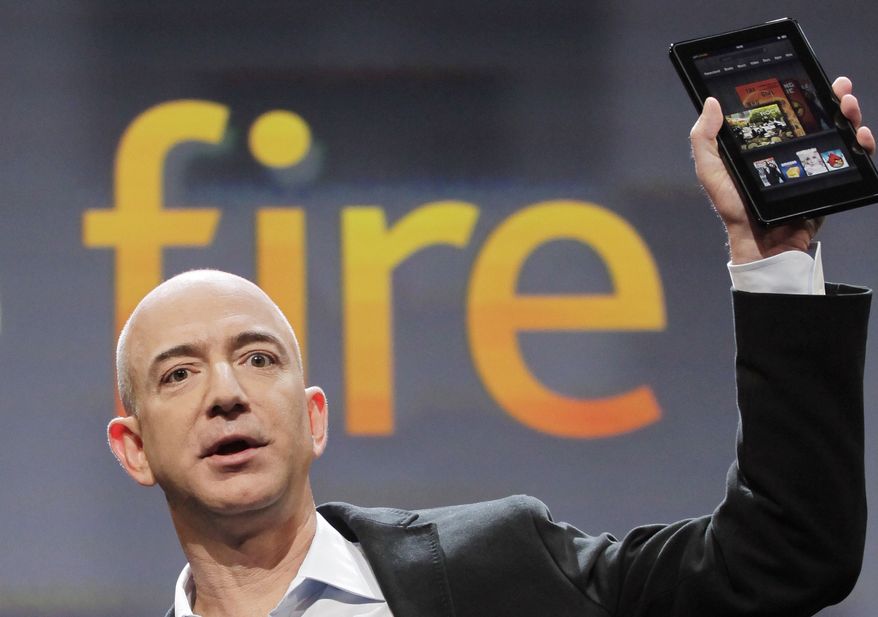 Jeff Bezos, chairman and CEO of Amazon.com, introduces the Kindle Fire at a news conference, Wednesday, Sept. 28, 2011, in New York. The e-reader and tablet has a 7-inch (17.78 cm) multicolor touchscreen. (AP Photo/Mark Lennihan)