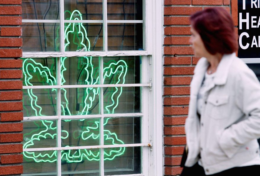 A marijuana leaf neon sign advertises a medical-pot provider in the Sherman Oaks section of Los Angeles. (Associated Press)