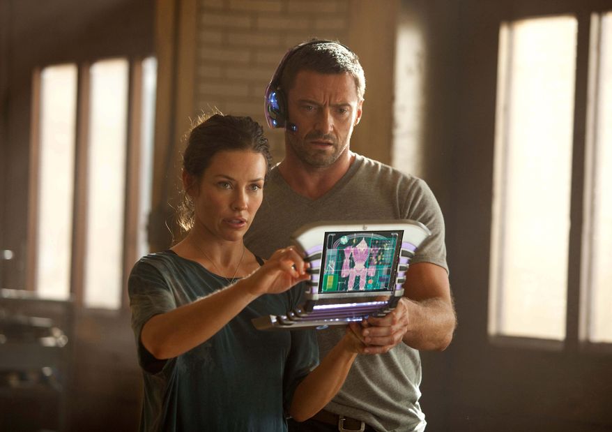 Evangeline Lilly as Bailey, in a scene with Hugh Jackson, is the go-to person when robots need repairs after their bouts in "Real Steel," rated PG-13 for mild profanity and robot mayhem. (Disney/Dreamworks II photograph via Associated Press)