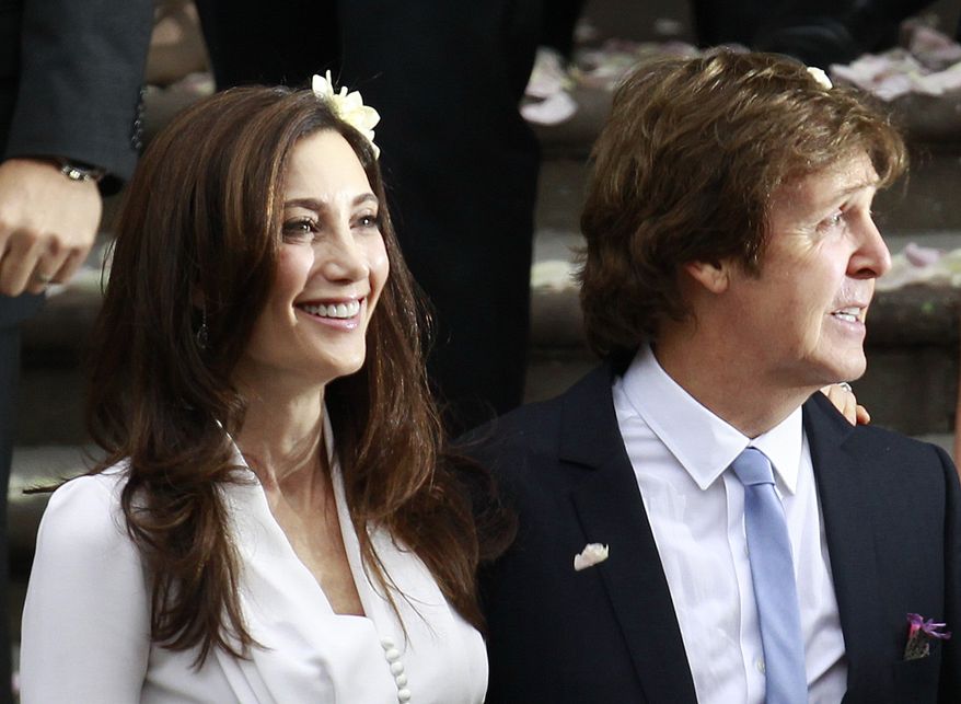 Sir Paul McCartney and his wife, American heiress Nancy Shevell, leave Marylebone Registry Office following their wedding in central London on Oct. 9, 2011. (Associated Press)