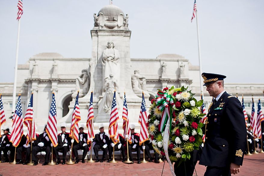 Representatives from the Italian Embassy present a wreath before the Columbus Memorial statue during a Columbus Day celebration and wreath presentation at Union Station in Washington on Monday, Oct. 10, 2011. (T.J. Kirkpatrick/The Washington Times)