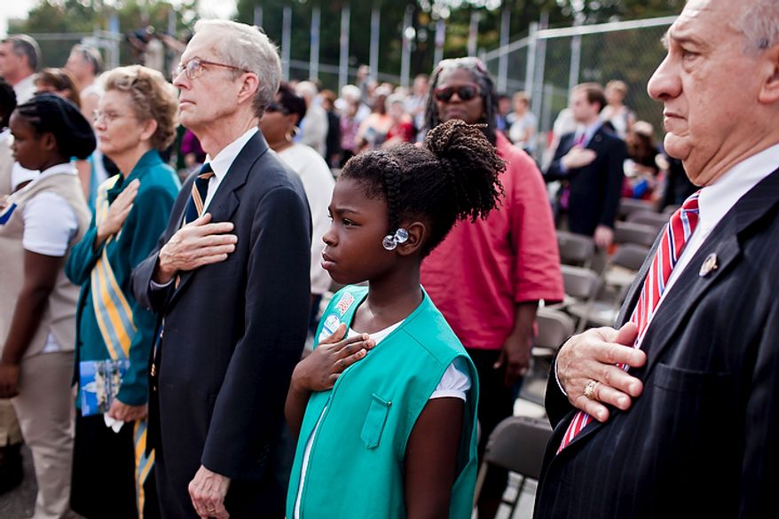 Wreath presenters Daniel Stabile (right), president of the National Council for the Promotion of Italian Language in American Schools; Bailey Moore (second from right), 9, with the Girl Scouts of the U.S.A.; David Stringfellow (second from left), governor of the D.C. branch of the Sons and Daughters of the Pilgrims; and Georgia Holder (left), national president of the Daughters of the American Colonists, stand for the Pledge of Allegiance during a Columbus Day celebration and wreath presentation at Union Station in Washington on Monday, Oct. 10, 2011. (T.J. Kirkpatrick/The Washington Times)