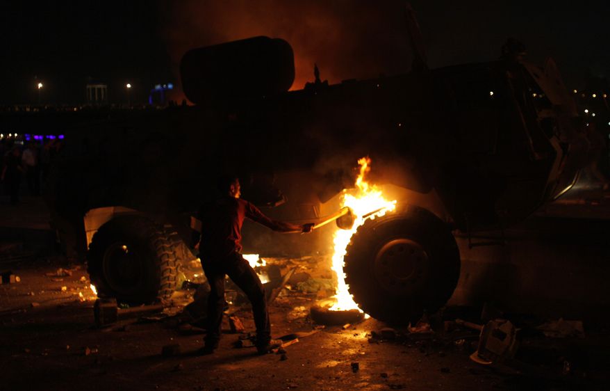A Coptic Egyptian demonstrator sets fire to an army vehicle during clashes with Egyptian army soldiers following a demonstration in Cairo on Oct. 9, 2011. (Associated Press)