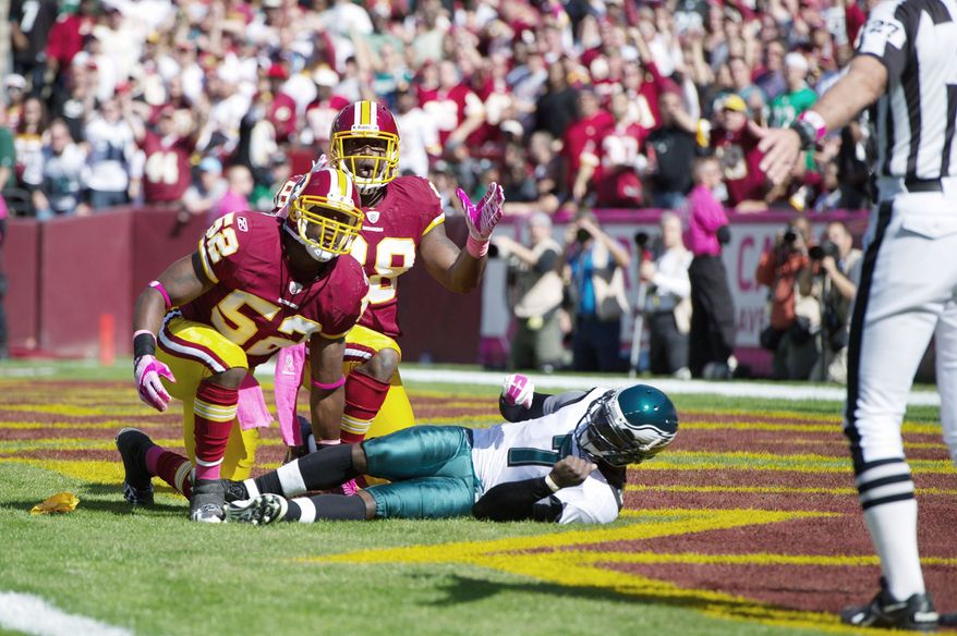 Redskins linebackers Rocky McIntosh (52) and Brian Orakpo react after McIntosh was flagged for roughing the passer during the first quarter. (Andrew Harnik/The Washington Times)
