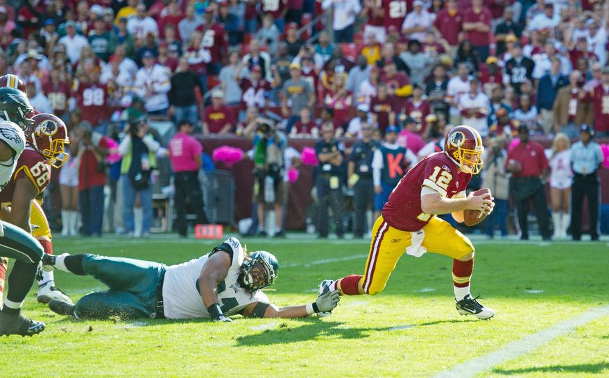 Redskins quarterback John Beck darts into the end zone from 2 yards out in the fourth quarter for Washington's only touchdown.