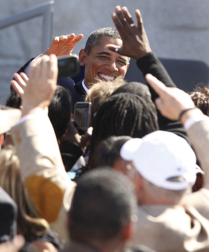 President Obama greets the audience during the dedication of the Martin Luther King Jr. Memorial in Washington on Sunday, Oct. 16, 2011. (AP Photo/Charles Dharapak)