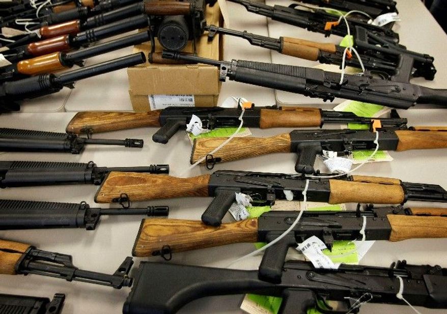 Seized weapons are displayed at a news conference in Phoenix in January. Weapons like these, which were walked into Mexico, are at the heart of the Fast and Furious investigation under way on Capitol Hill. (Associated Press)