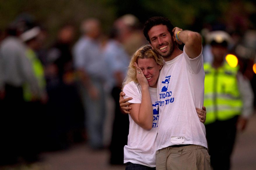 People react as Israeli soldier Gilad Schalit, freed in a swap for Palestinian prisoners, arrives home in Mitzpe Hila. (AP Photo/Oded Balilty)