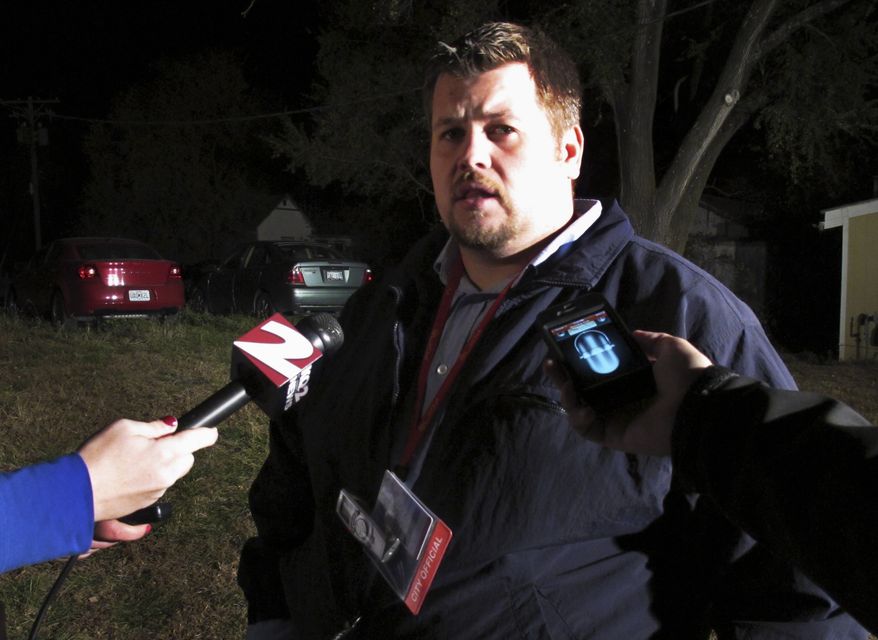 Atchison, Kan., City Manager Trey Cocking talks with reporters near the Bartlett Grain Co. elevator on Saturday, Oct. 29, 2011, after an explosion at the elevator killed three people and left three others missing. (AP Photo/John Hanna)