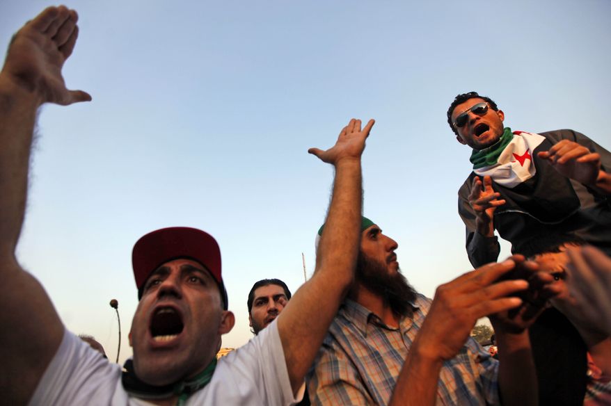 Protesters chant slogans Nov. 2, 2011, during a demonstration against the Syrian regime, held in front of the Arab league headquarters in Cairo. (Associated Press)