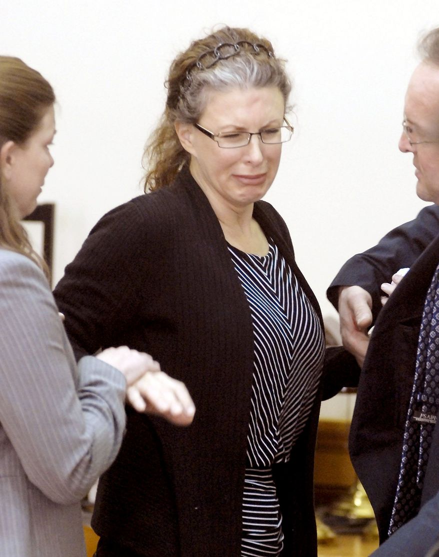 Tracey Richter is consoled at Webster County District Court in Fort Dodge, Iowa, on Monday after a jury convicted her of murder in the 2001 death of her 20-year-old neighbor. Richter faces life in prison at her Dec. 5 sentencing. (Associated Press)