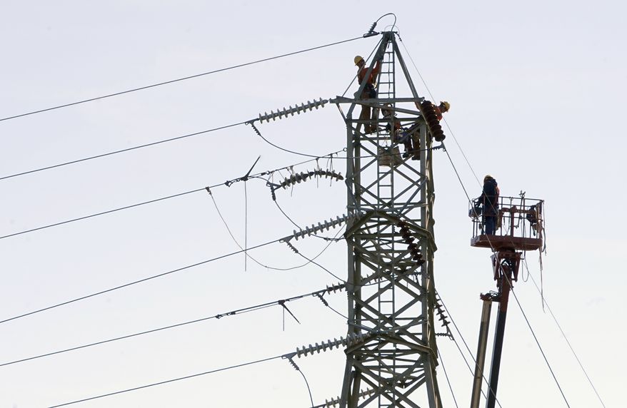 ** FILE ** Connecticut Light & Power workers tend to a high-voltage power line in Windsor Locks, Conn., on Wednesday, Nov. 2, 2011. (AP Photo/Jessica Hill, File)