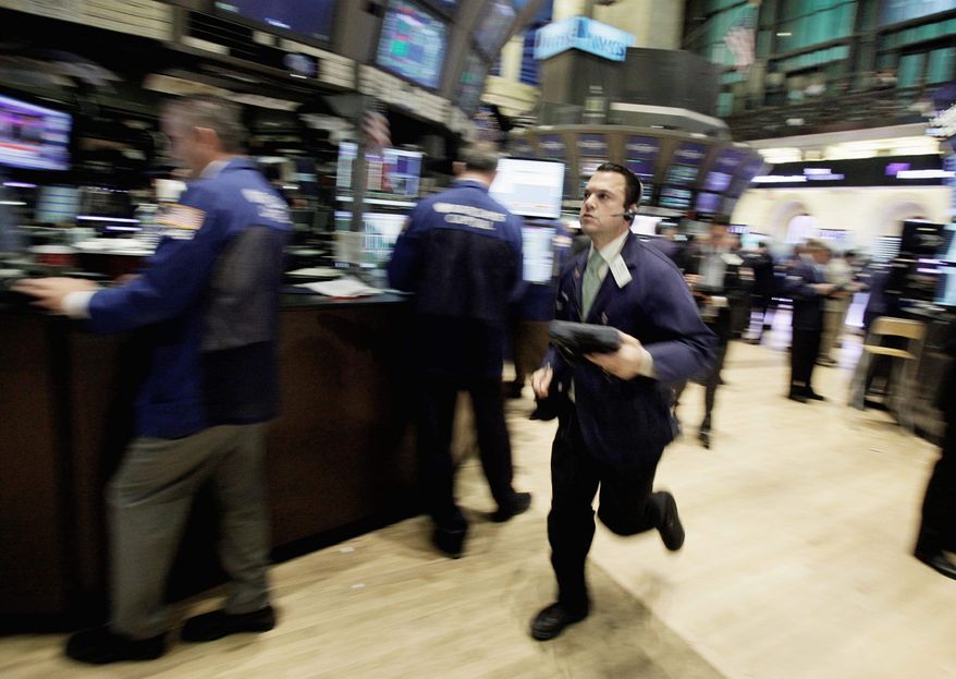 Trader Michael Zicchinolfi runs across the New York Stock Exchange floor on Wednesday. The Dow Jones industrial average fell nearly 400 points as the European debt crisis sent American stocks into a tailspin. (Associated Press)