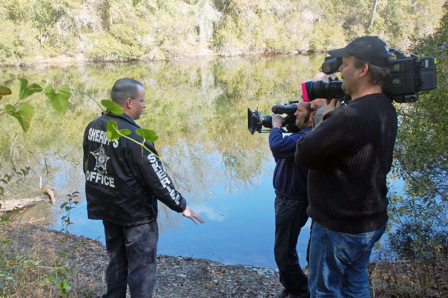 Lt. Damon Hall, a crime scene investigator with the Montgomery County, Texas, Sheriff's Office, is filmed for "Into the Abyss" about the perpetrators and victims in a 2001 triple murder. (Sundance Selects via Associated Press)