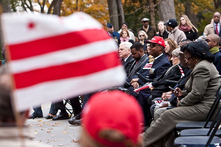 A District of Columbia flag is flown during a rededication ceremony following renovations of the District of Columbia WWI Memorial in Washington, D.C. on Nov. 10, 2011. District leaders spoke out against a plan to rename the memorial to be a national and D.C. memorial, arguing that the District should be allowed to keep their memorial since each state has a dedicated memorial to those residents who served in WWI.
(T.J. Kirkpatrick/ The Washington Times)