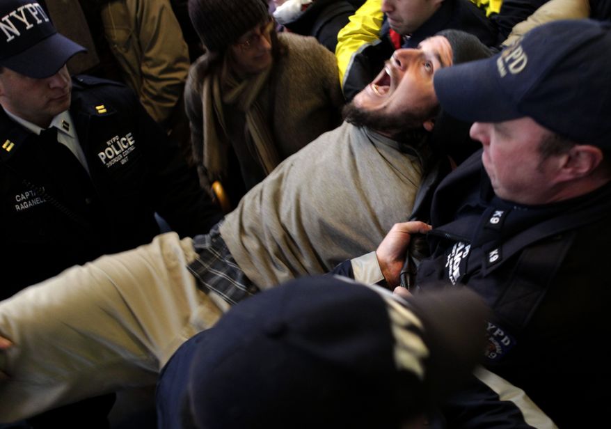 An Occupy Wall Street protester yells as he is arrested by the police after blocking an intersection near the New York Stock Exchange on Nov. 17, 2011. (Associated Press)