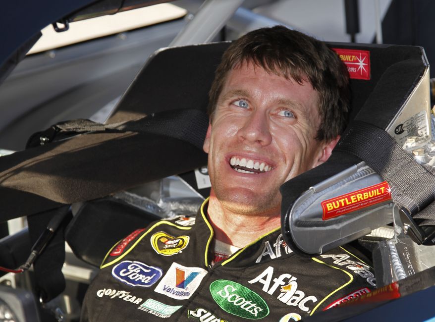 Driver Carl Edwards smiles after qualifying for Sunday's NASCAR Ford 400 Sprint Cup series auto race at Homestead-Miami Speedway in Homestead, Fla., Saturday, Nov. 19, 2011. Edwards won the pole position for the race. (AP Photo/Terry Renna)