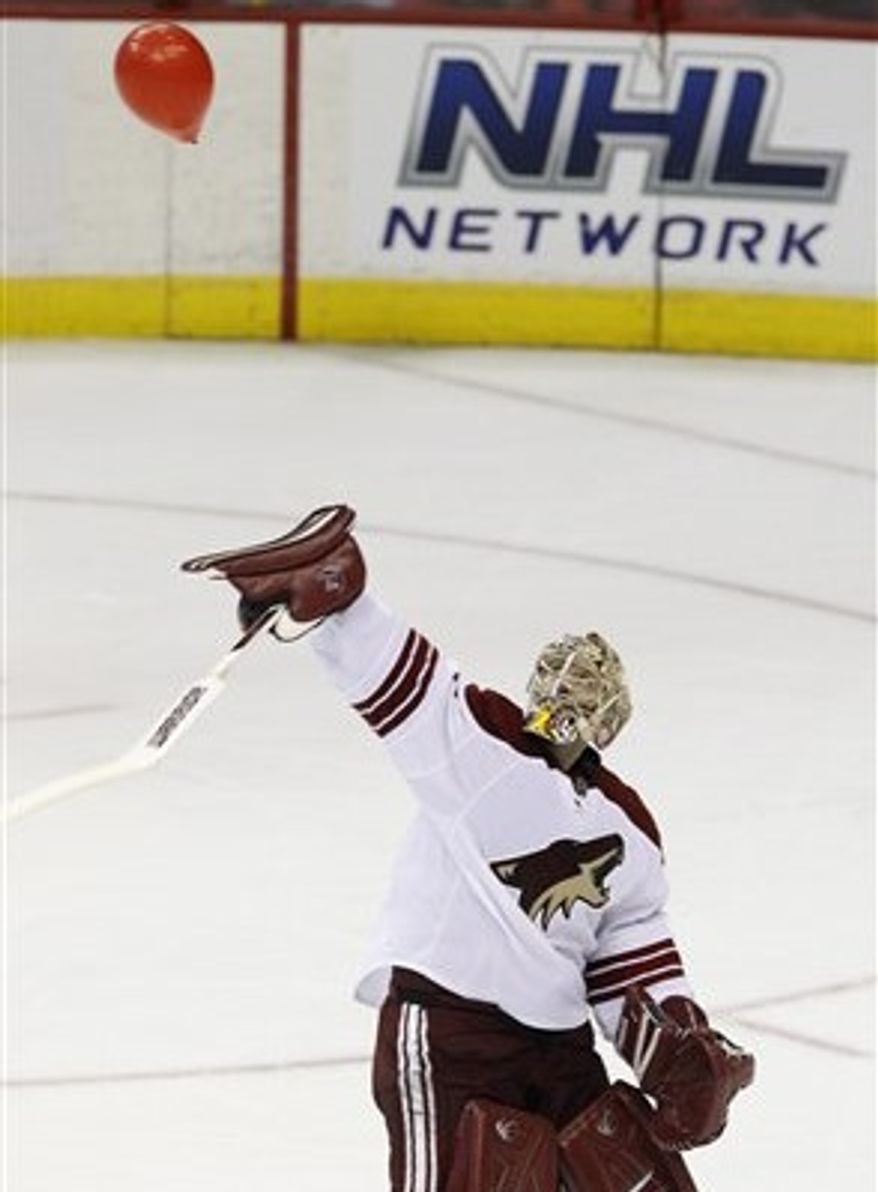 Jason LaBarbera tries to swat down red ballon during second period. (Associated Press)