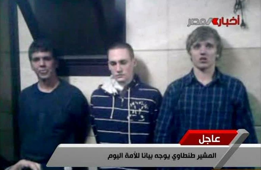 ** FILE ** In this Tuesday, Nov. 22, 2011, file image from Egyptian state television, three American students are displayed to the camera by Egyptian authorities following their arrest during protests in Cairo, where an Egyptian official said they were throwing firebombs at security forces. A spokeswoman for the American University in Cairo identified the students as Luke Gates, a 21-year-old Indiana University student from Bloomington, Ind.; Derrik Sweeney, a 19-year-old Georgetown University student from Jefferson City, Mo.; and Gregory Porter, a 19 year-old Drexel University student from Glenside, Pa. (AP Photo/Egyptian TV, File)