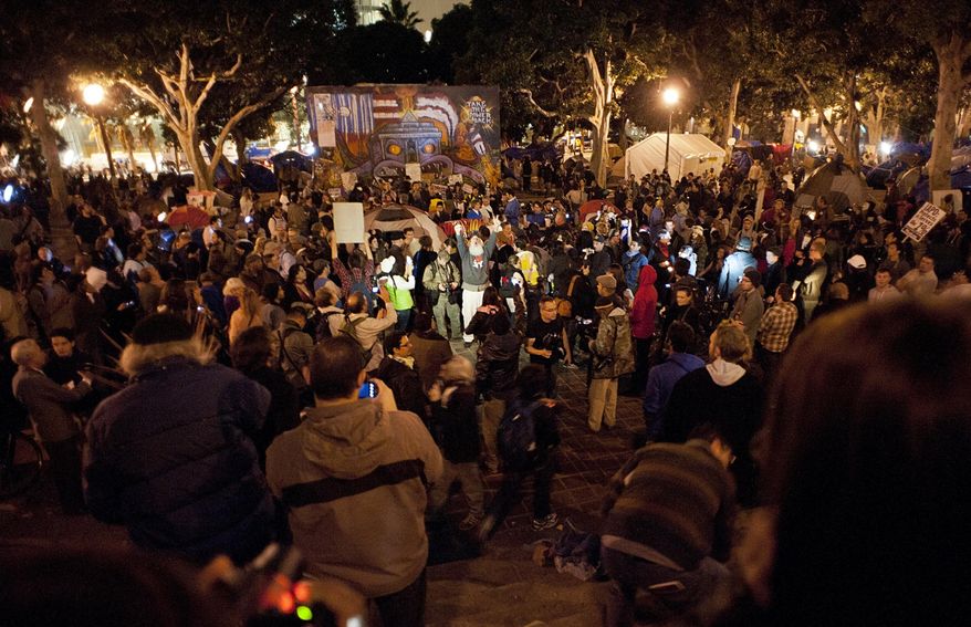 A crowd gathers during the Occupy L.A. protest in Los Angeles on Tuesday, Nov. 29, 2011. Officers began a raid on the camp early Wednesday, two days after a deadline passed for protesters to clear out. (AP Photo/Dan Steinberg)