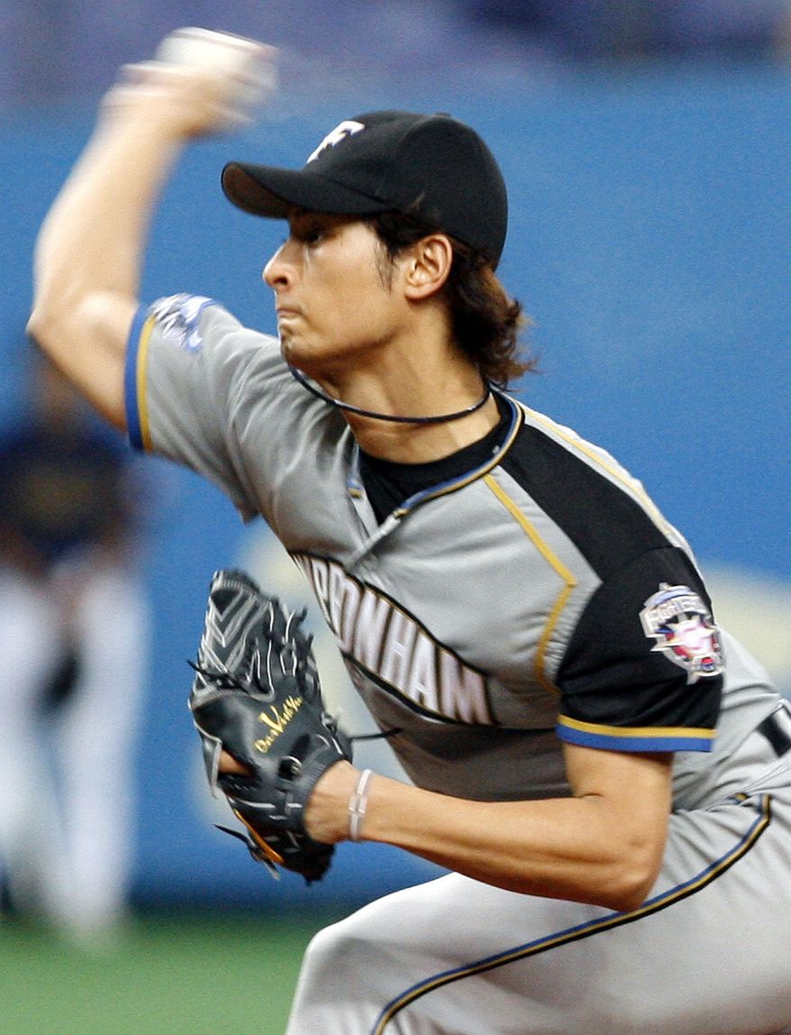 ** FILE ** In this Sept. 5, 2007, file photo, Nippon Ham Fighters starter Yu Darvish pitches against the Orix Buffaloes in Osaka, western Japan. (AP Photo/Kyodo News, File)
