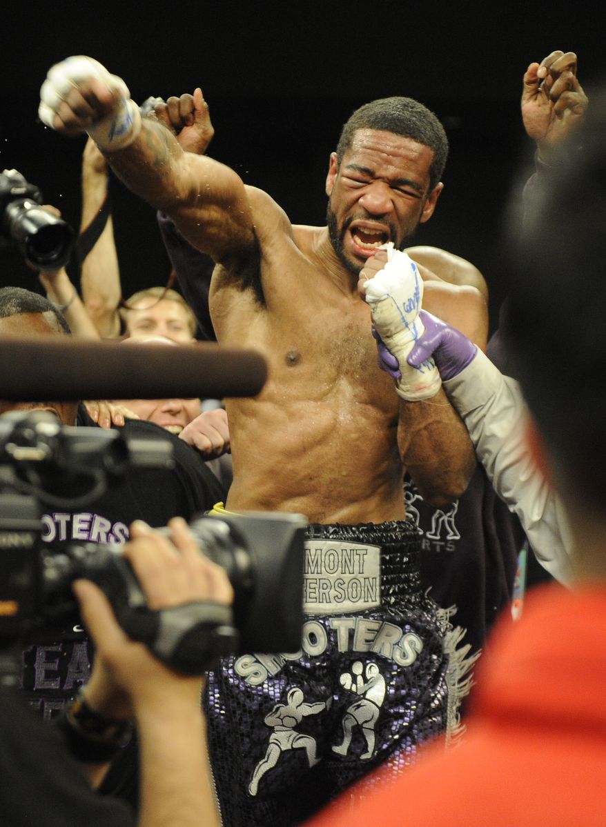 Lamont Peterson celebrates his win over Amir Khan in a boxing match, Sunday, Dec. 11, 2011, in Washington. (AP Photo/Nick Wass)