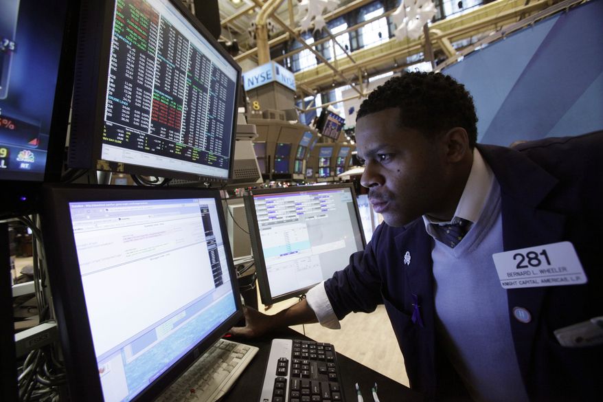 Specialist Bernard Wheeler works on the floor of the New York Stock Exchange on Dec. 12, 2011. (Associated Press)