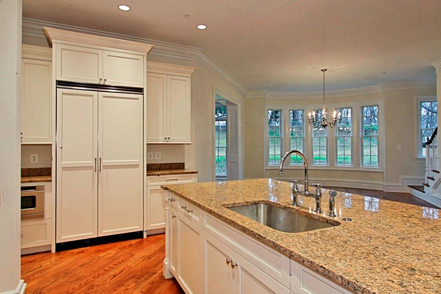 The kitchen opens to the family dining room, which has a bay window.