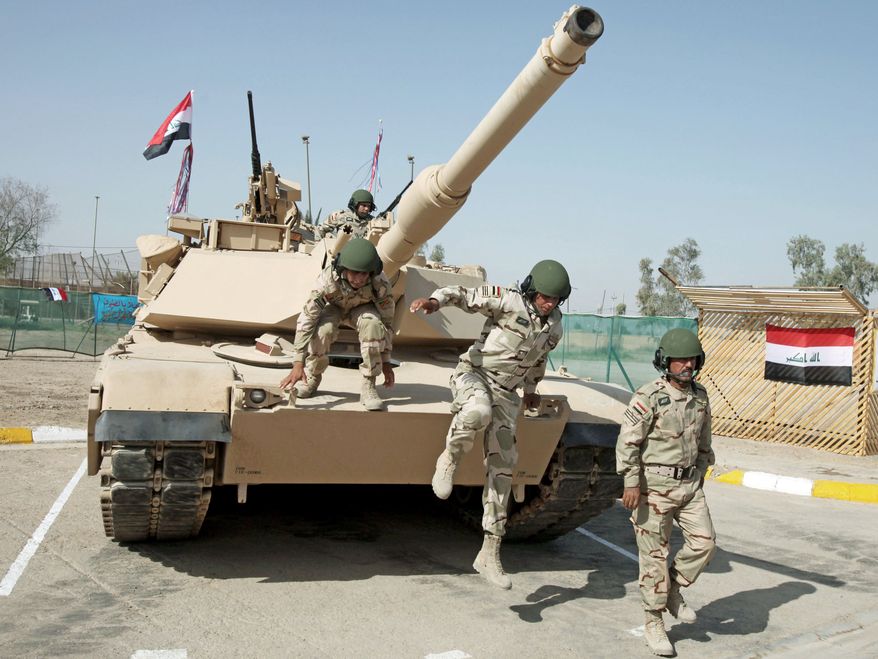ON THEIR OWN: Iraqi army soldiers train with an M1 Abrams tank, purchased from the U.S., during an exercise in Baghdad.